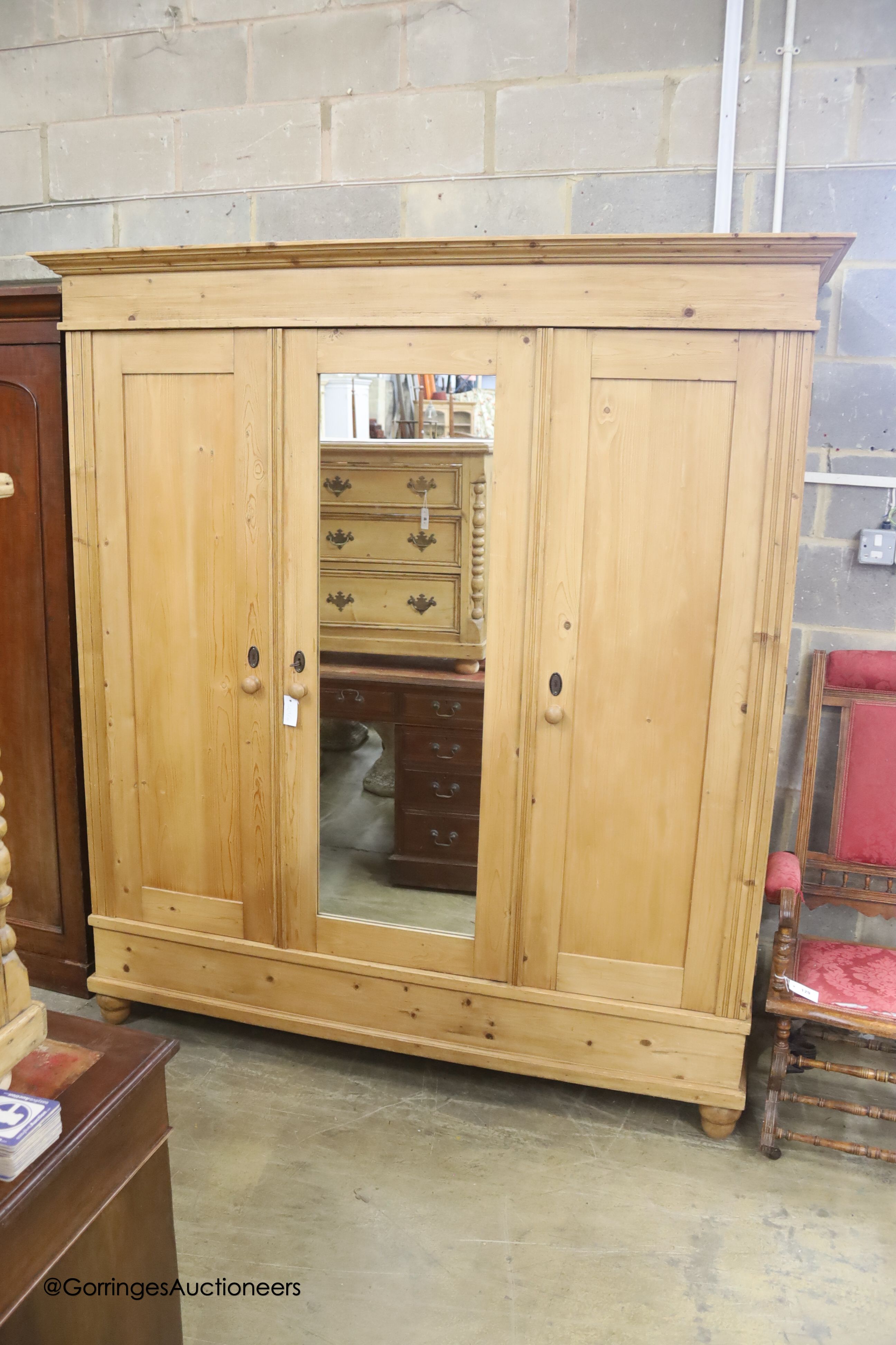 A 19th century East European pine knock-down mirrored wardrobe, width 180cm depth 70cm height 200cm